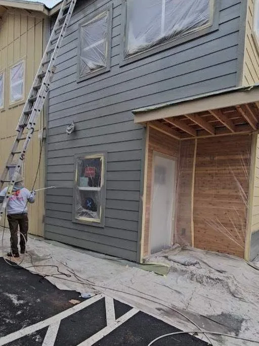 Commercial building exterior siding painting in progress