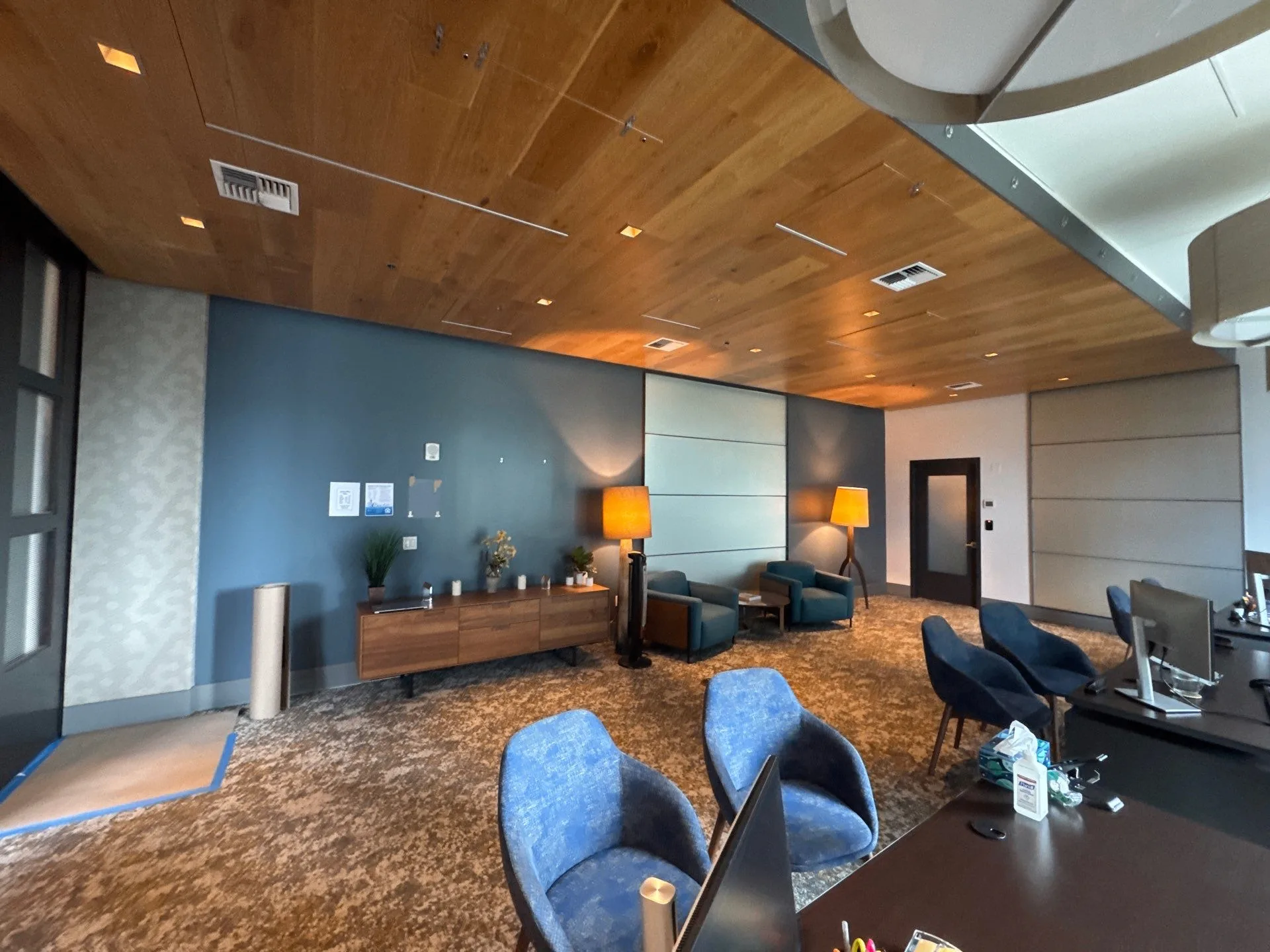 Commercial lobby with blue accent wall and wood ceiling after painting