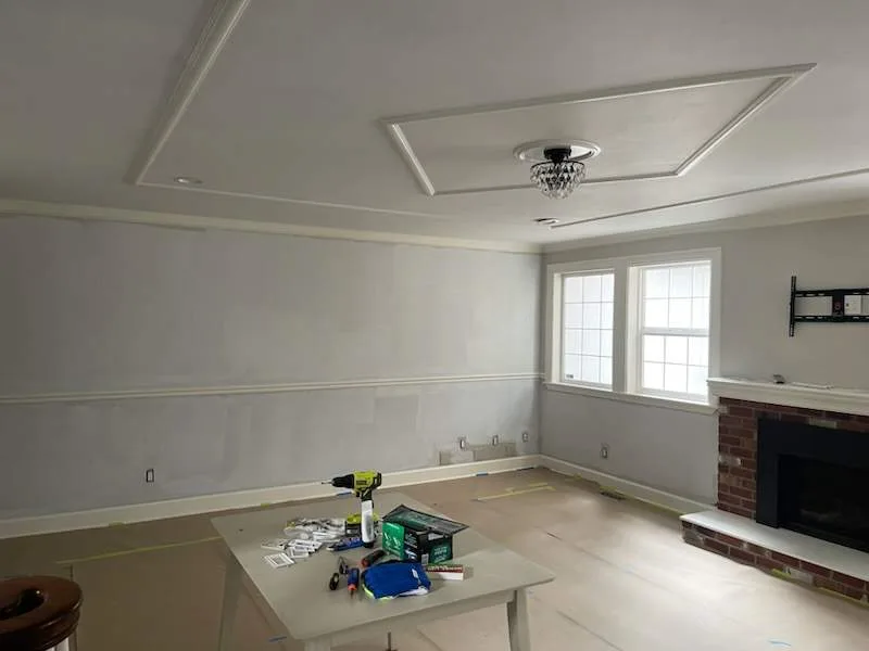 Living room drywall repair and prep with crown molding