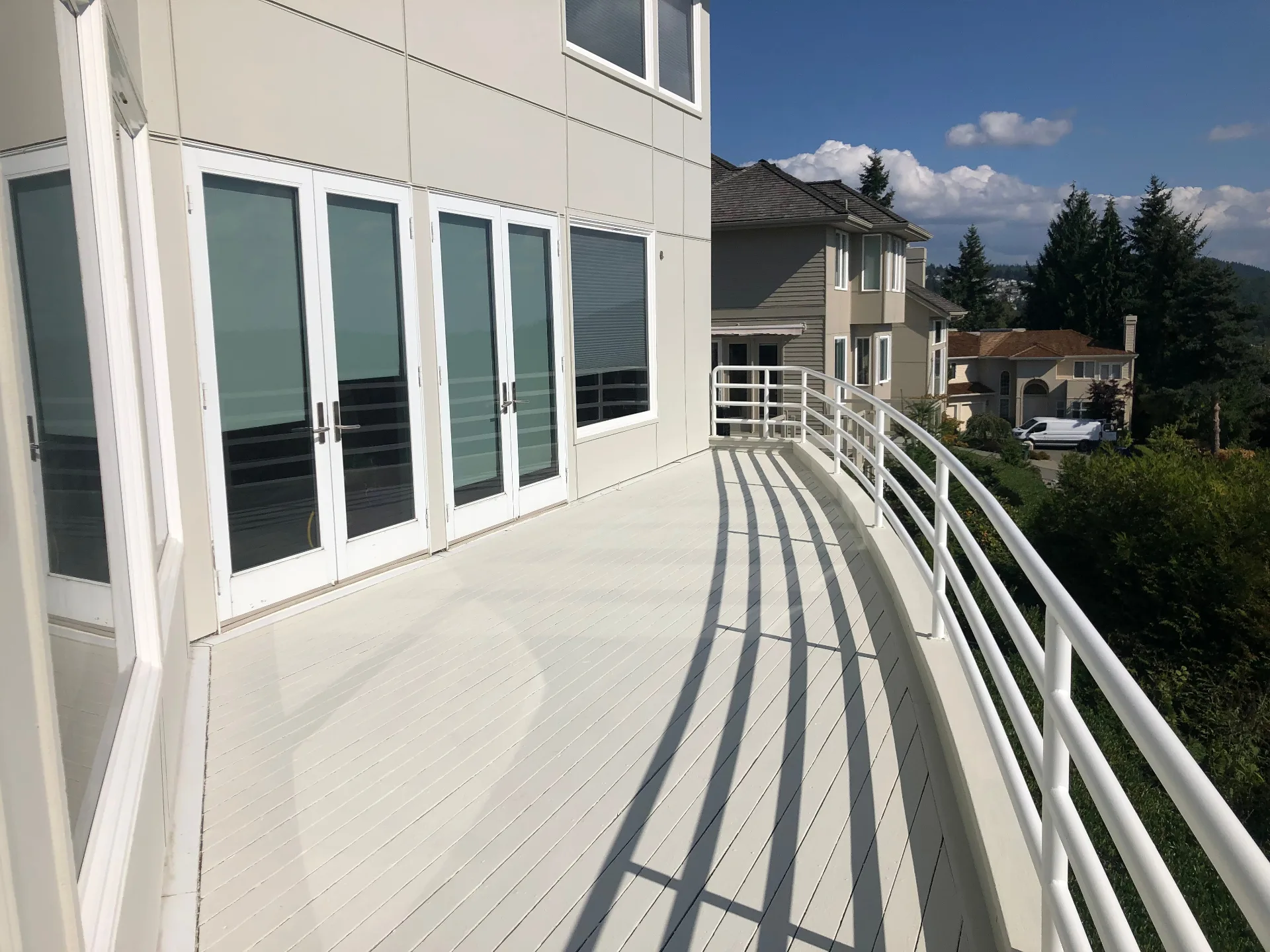 Freshly painted white deck and railing after exterior painting