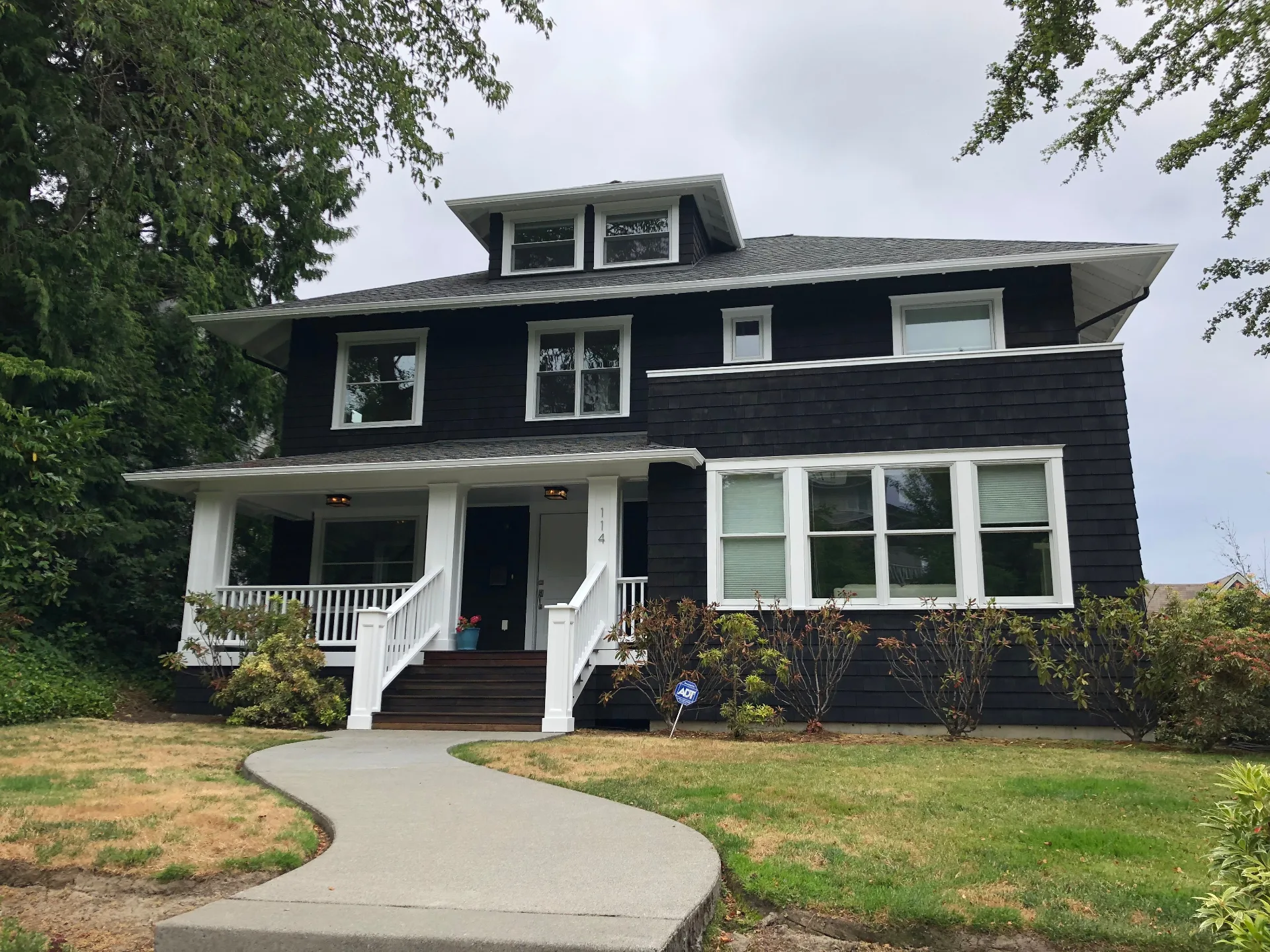 Dark craftsman home exterior after professional painting